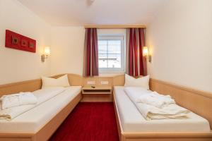 Łóżko lub łóżka w pokoju w obiekcie Appartements Olympia