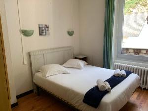 Un pat sau paturi într-o cameră la Le Pourquoi pas