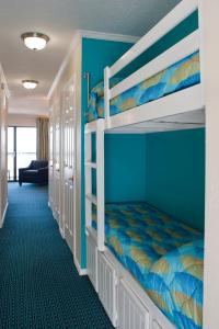 a bedroom with two bunk beds in a room at Casa Del Mar Beachfront Suites in Galveston