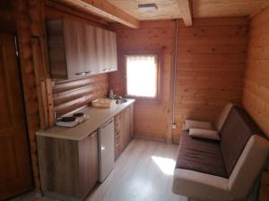 a kitchen in a log cabin with a bench in it at Vikendica Matovic Ovcar Banja in Ovčar Banja