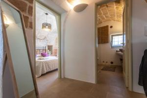 a hallway leading to a bedroom with a bed at Dimora la Pinta ‘700 in Gallipoli
