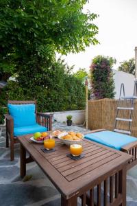 a wooden table with bowls of fruit on a patio at Eden’s garden in Chania Town