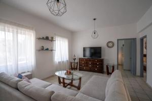 a living room with a couch and a table at Eden’s garden in Chania Town