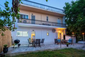 a patio with chairs and tables in front of a building at Eden’s garden in Chania Town