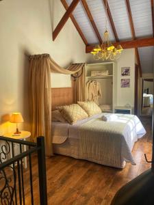 a bedroom with a bed with a canopy at Pousada La Lavande in Gramado