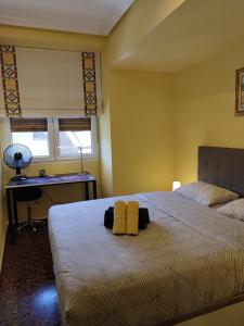 a bedroom with a bed with two yellow towels on it at T&C HARO in Haro