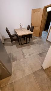 a dining room with a table and chairs on a tile floor at Batea 1 in Seline