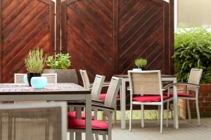 a patio with a table and chairs and a fence at NH Hamburg Altona in Hamburg