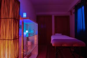 a room with a bed and a blue and purple light at Yomo Eureka in Andorra la Vella
