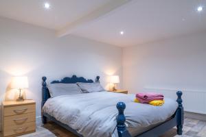 a bedroom with a blue bed and two night stands at Retreat Lodge in Muff