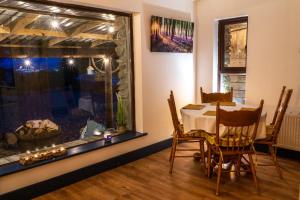 a dining room with a table and a large window at Retreat Lodge in Muff