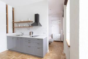 a kitchen with a sink and a counter at Art & Comfort Home in Kaunas +209 photos