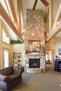 a living room with a stone fireplace at Interlachen Unit 18 in Nisswa