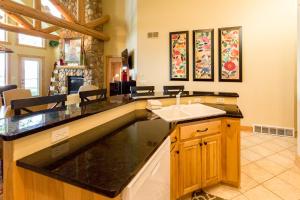 a kitchen with a sink and a living room at Interlachen Unit 18 in Nisswa
