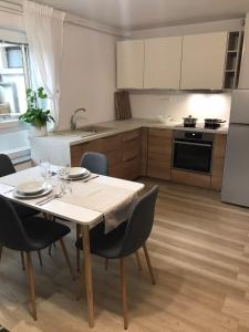 a kitchen with a table and chairs in a kitchen at Koradinovi - Pod vrtom in Vipava