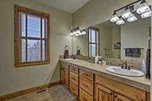 a bathroom with two sinks and a large mirror at Golf, Ski and Hike Luxe Group Getaway in Granby! in Granby +33 photos