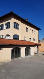 a large white building with windows and a roof at Koradinovi - Pod vrtom in Vipava