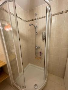 a shower with a glass door in a bathroom at La Room: seaside apartment + terrace + parking in Menton