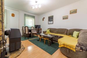 a living room with a couch and a table at Vikendica MRVICA in Bajina Bašta