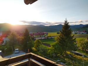 a view from the balcony of a house with the sunset at Apartman Ana in Mrkopalj