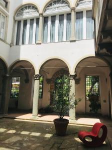 a large white building with a large window at Corte Meraviglia - Relais in Lucca