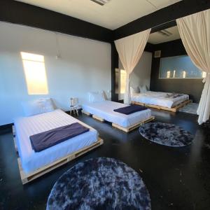 a bedroom with two beds and two rugs at FrenTé Chiang Mai in Chiang Mai +37 photos