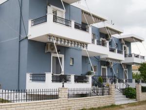 a blue building with white balconies and stairs at Mak Luxury Rooms in Parga