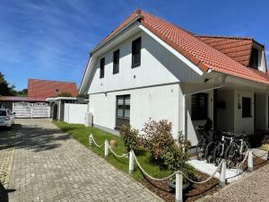 una casa blanca con bicicletas estacionadas fuera de ella en Ferienhaus Schwan en Neu Pastitz
