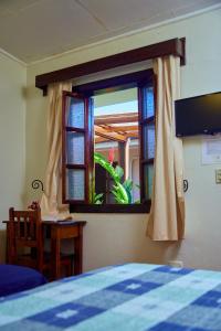 Vuode tai vuoteita majoituspaikassa La Posada Copan
