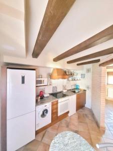 a kitchen with a white refrigerator and a sink at CASA RURAL SANTA AGUEDA in Jaraba +41 photos