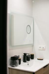 a bathroom counter with a mirror and a sink at Atelier chaleureux - CDG in Tremblay En France
