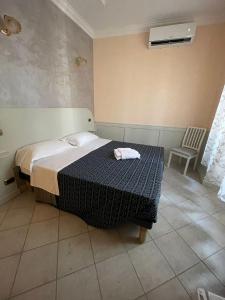 a bedroom with a bed and a chair in it at Casa di Stefano in Rome