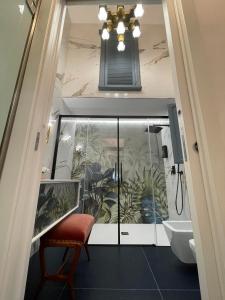 a hallway with a bathroom with plants on the wall at I Bastioni Apartment in Palermo