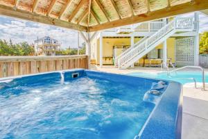 a large swimming pool with a wooden deck and a house at Under The Boardwalk in Avon