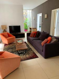 a living room with two couches and a table at Elegant Villa in Grand Baie with Pool in Grand Baie
