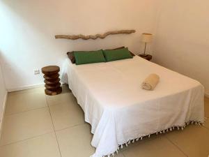 a bedroom with a large white bed with green pillows at Elegant Villa in Grand Baie with Pool in Grand Baie +6 photos