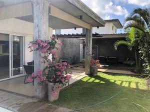 a house with a garden with flowers in a yard at Elegant Villa in Grand Baie with Pool in Grand Baie