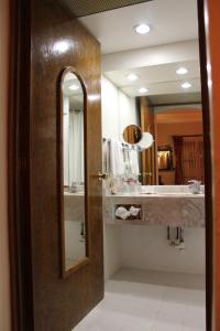 a bathroom with a sink and a mirror at Hotel Casa Conzatti in Oaxaca City