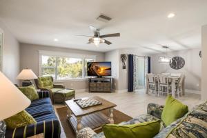 a living room with a couch and a table at Royal Palm: Pool, 2 Blocks to Beach, Close to Dining & Shopping by Anna Maria Life Vacation Rentals in Holmes Beach
