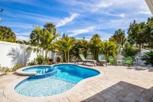 a swimming pool in a backyard with a patio furniture and trees at Royal Palm: Pool, 2 Blocks to Beach, Close to Dining & Shopping by Anna Maria Life Vacation Rentals in Holmes Beach