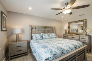 a bedroom with a bed and a ceiling fan at Royal Palm: Pool, 2 Blocks to Beach, Close to Dining & Shopping by Anna Maria Life Vacation Rentals in Holmes Beach +17 photos