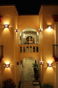 a hallway of a house with lights on the walls at Hotel Casa Conzatti in Oaxaca City