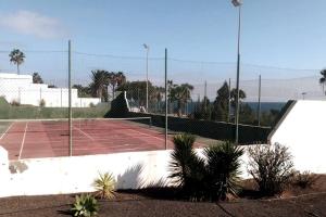 um campo de ténis com rede num campo de ténis em TUSCAN Apartment mit Meerblick und Sonnenterrasse em Costa Teguise
