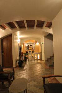 a living room with a staircase and a lobby at Hotel Casa Conzatti in Oaxaca City