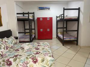 a room with three bunk beds and a bed at Ipanema Club Hostel in Rio de Janeiro