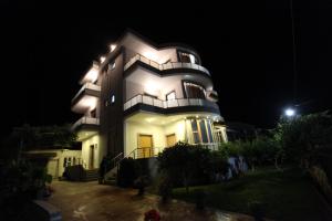 a large building with lights on it at night at Vila Olserd Shehu in Ksamil