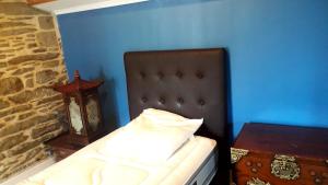 a bed in a room with a blue wall at Le cocon in Cherbourg en Cotentin