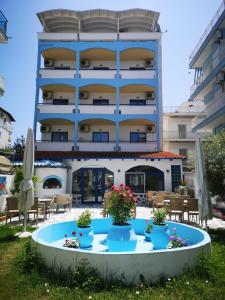 a building with a table in front of it at PIERIA MARE in Paralia Katerinis