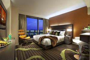 a bedroom with a large bed and a large window at Hard Rock Hotel San Diego in San Diego