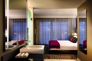 a hotel room with two beds and a mirror at Hard Rock Hotel San Diego in San Diego